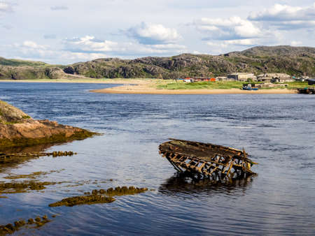 Sunken old wooden fishing boat in Teriberka, Murmansk Oblast, Russiaの写真素材