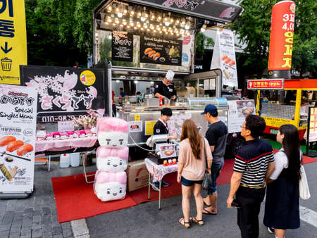 Seoul, South Korea - June 17, 2017: People queuing up at the fast food kiosk at the street near Cheonggyecheon stream in Seoul. Street food is very popular in Korea.のeditorial素材