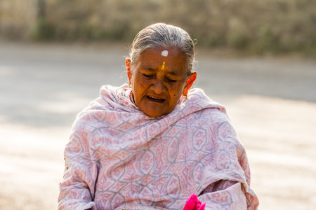 Pokhara, Nepal - November 21, 2015: Elderly woman in traditional dress on the street in Pokhara