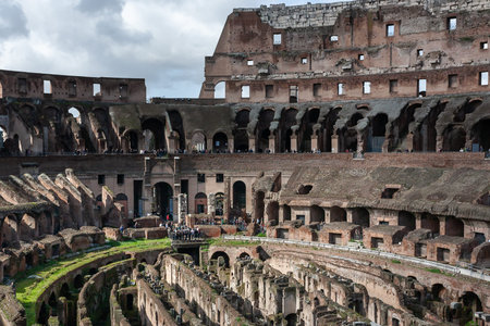 Rome, Italy - February 24, 2010: Tourists walking among the ruins of the Roman Colosseum