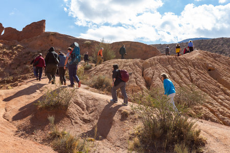 Tosor, Kyrgyzstan - October 1, 2022: Tourists walk around Fairytale canyon or Skazka Canyon, Natural park of colorful rocks near Issyk-Kul lake, Kyrgyzstan.のeditorial素材
