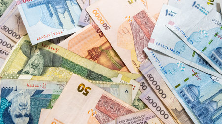 Background from different Iranian Rial or IRR banknotes from Iran. Concept of economic crisis and...