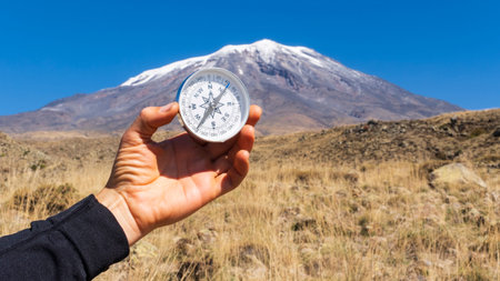 Round compass in hand on the background of Mount Ararat. Concept for travelling and active...