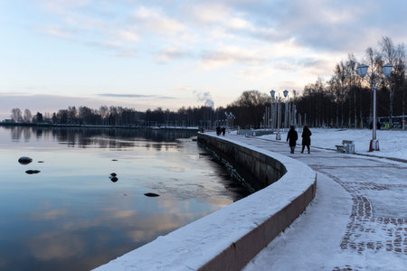 Petrozavodsk, Russia - December 8, 2024: People walking along the snow-covered embankment of Lake Onega in Petrozavodsk.のeditorial素材