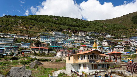 Namche Bazaar, Nepal - October 9, 2025: Trekkers enter the village of Namche Bazaar through a gate.のeditorial素材