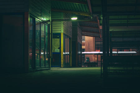 Central marketplace at night time. Isolated territory filled with trading stands and lighten by city lights. Spooky and abandoned atmosphere in urban market territory.のeditorial素材