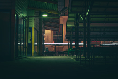Central marketplace at night time. Isolated territory filled with trading stands and lighten by city lights. Spooky and abandoned atmosphere in urban market territory.のeditorial素材