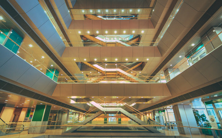 National library of Latvia. Modern architectural masterpiece. Multilevel floors with staircases and bookshelves in background.のeditorial素材