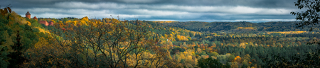 Picturesque view on valley of Gaujas national park. Trees changing colors in foothills.  Colorful Autumn day at city Sigulda in Latvia.のeditorial素材