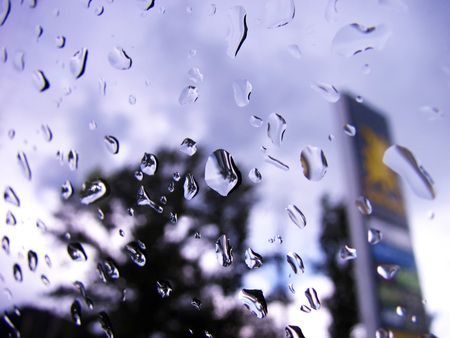 The total flow of automobile window glass surface rain drops.の写真素材