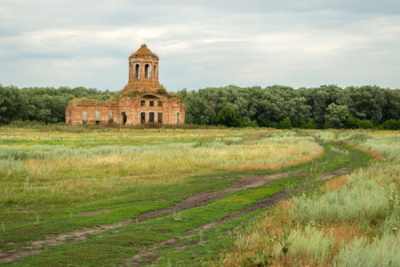 Thrown old church on a green countryside meadowの写真素材