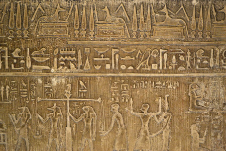 Cairo, Egypt - 19th May, 2018: Egyptian hieroglyphs symbols and signs on a stone wall. Exhibiting...
