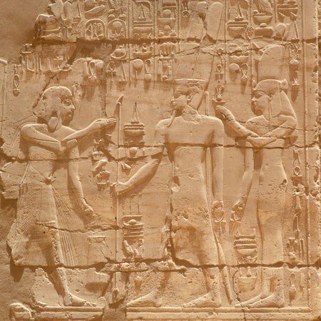 Egyptian hieroglyphs, symbols and signs on a stone wall in Karnak temple. Elements and details of...