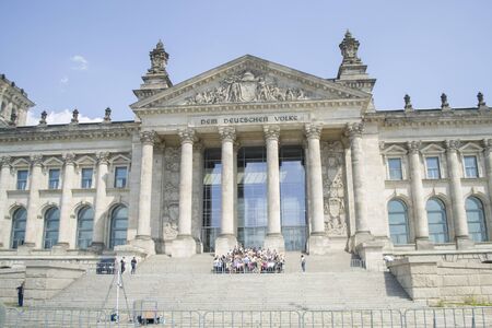 Berlin, Germany - 4th June, 2019: Reichstag building is the Bundestag Parliament. German parliament with group of tourists near it. The inscription on the facade: For the German people.のeditorial素材