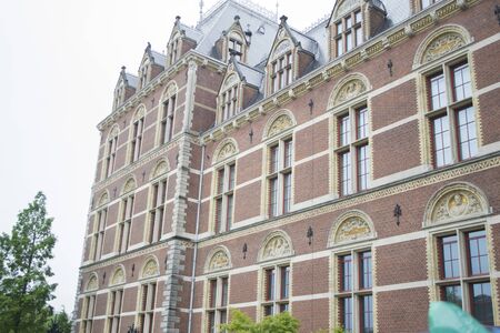 Amsterdam, Netherlands - 5th June, 2019: Dutch national art museum. Closeup of part of the Reichsmuseum building in Amsterdam. Decorations and detailes of the facade, roof and windows of the museum building.のeditorial素材