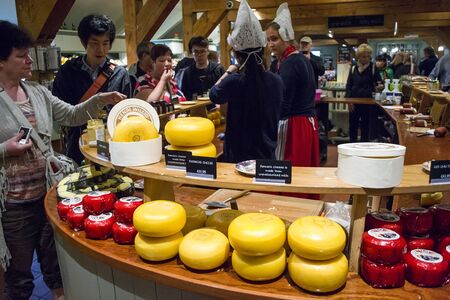 Zaanse Schans, Netherlands - 5th June, 2019: Tourists are tasting Dutch fermer cheese in the showroom of an old cheese factory in Zaandam, Zaans Schans.のeditorial素材
