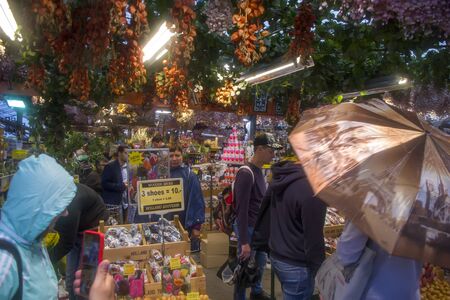 Amsterdam, Netherlands - 5th June, 2019: Amsterdam Floating Flower Market interior. Tourists and visitors look at Dutch souvenirs at the entrance to the famous floating tulip market.のeditorial素材