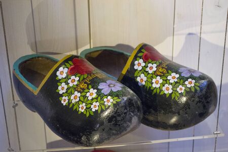 Zaanse Schans, Netherlands - 5th June, 2019: Traditional Dutch hand made wooden farmers shoes. Pair of old klompen in the exhibition hall at the Clog Museum and hand made clogs studio in Zaanse Schansのeditorial素材