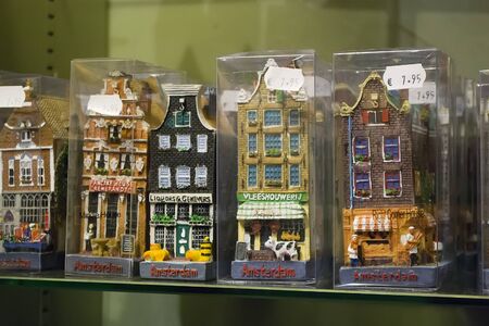 Zaanse Schans, Netherlands - 5th June, 2019: Group of handmade ceramic traditional houses, individually packed, stand on a shelf in a store. Typical souvenirs from Holland, the Netherlands.のeditorial素材