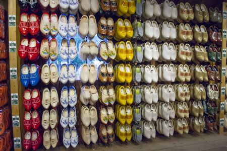 Zaanse Schans, Netherlands - 5th June, 2019: Exhibition and sale traditional, painted Dutch clogs in a workshop. The famous souvenir from Holland. Shelves with lots of shoes pair in the store.のeditorial素材