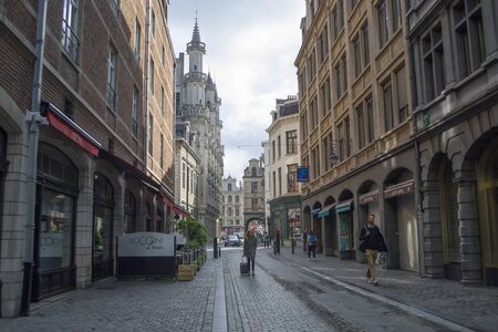 Brussels, Belgium - 6th June, 2019: Views of the avenues of Brussels. The street leading to the main square of the city - Grand Place or Grand Square. Ancient buildings rise from two sides.のeditorial素材