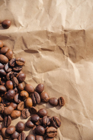 Coffee beans on crumpled brown paper, can be used as backgroundの写真素材