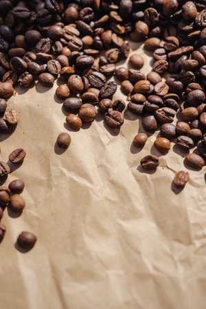 Coffee beans on brown paper background, can be used as a backgroundの写真素材