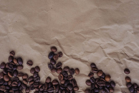 Coffee beans on brown paper background. top view with copy spaceの写真素材