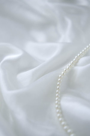 Pearl necklace on white satin background, shallow dof.の写真素材