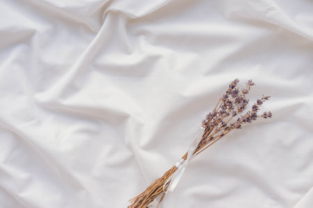 Top view of lavender bouquet on white fabric background with copy spaceの写真素材