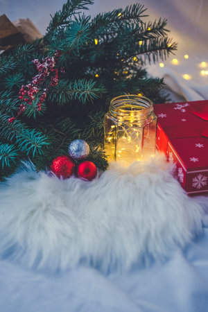 Christmas tree with decorations on the background of a garland and giftsの写真素材