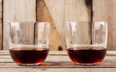 Whiskey glass on black glass surface'