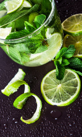 Studio shot of fresh mojito drinks with slime slices, isolated on black backgroundの写真素材