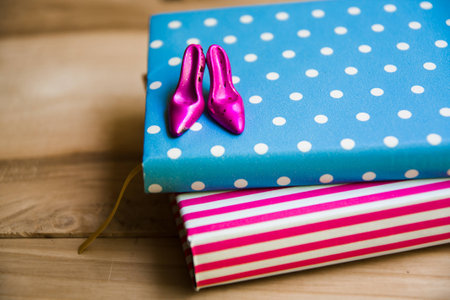 shoes on a notebook with wooden backgroundの写真素材