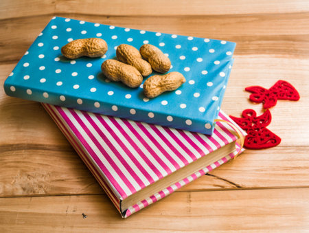 notebook with nuts on a wooden backgroundの写真素材