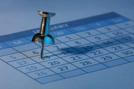 Push pin in calendar with blue light