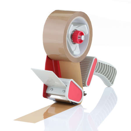 Parcel tape dispenser with brown roll of tape on white backgroundの写真素材