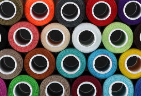 Colored cotton reels background pattern close upの写真素材