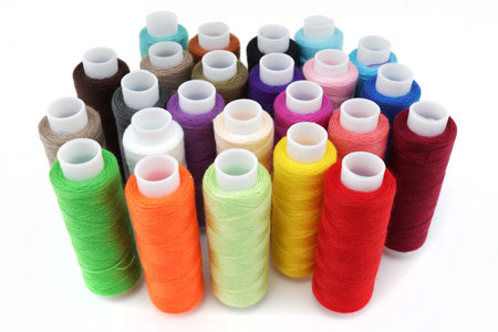 Multicolored cotton reels on a white surface