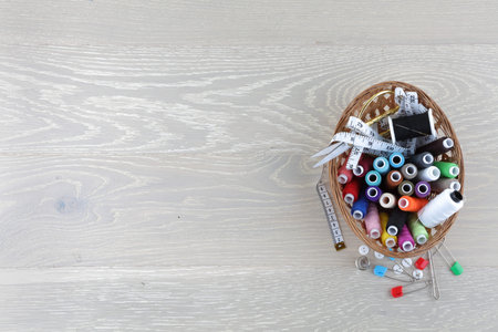 sewing basket on a wood surface with copy space