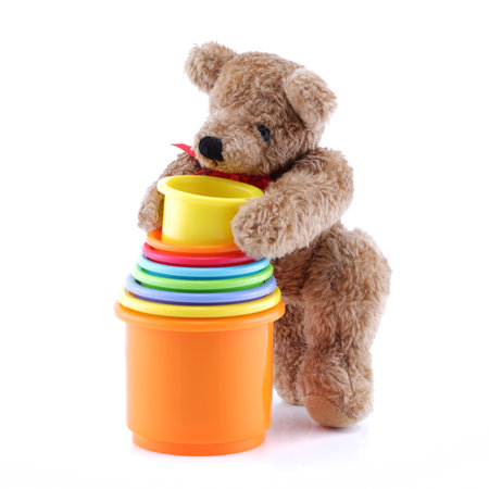 Brown teddy bear playing with toy pots containersの写真素材
