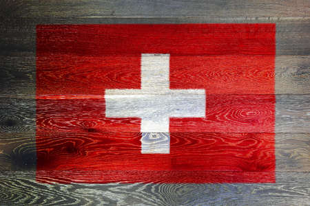 Switzerland flag on rustic old wood surface backgroundの写真素材