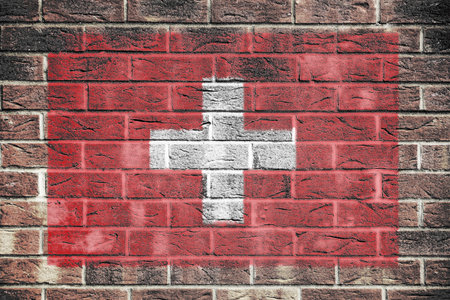 Switzerland flag on a brick wall backgroundの写真素材