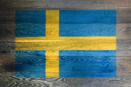 Sweden flag on rustic old wood surface backgroundの写真素材