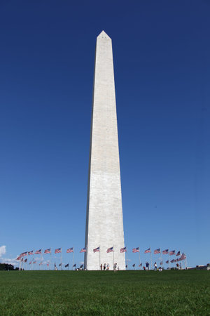Washington Memorial showing circle of flags in blue sky