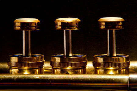 Valves on a trumpet in a line