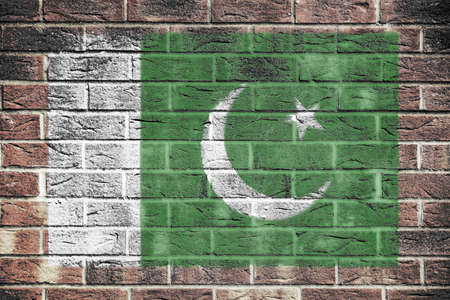 A Pakistan flag on old brick wall backgroundの写真素材