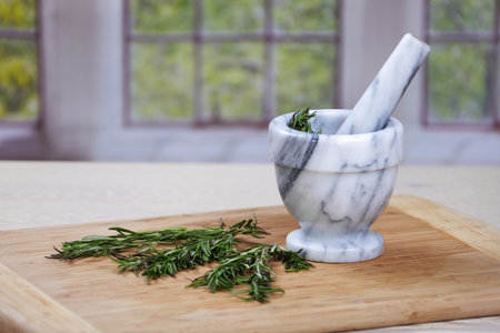 Rosemary herbs and a mortar and pestleの写真素材