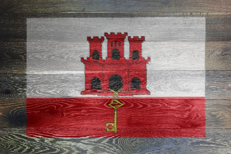 Gibraltar flag on rustic old woodの写真素材