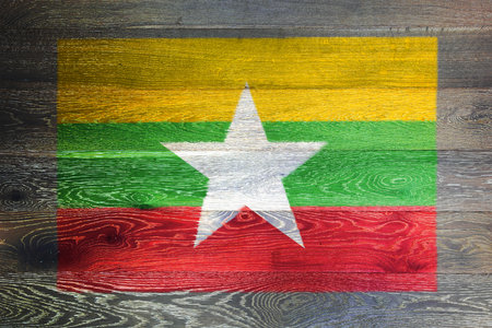 Myanmar flag on rustic old wood surface backgroundの写真素材